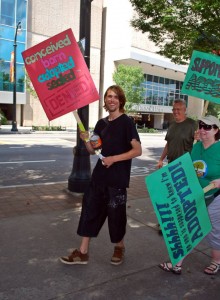 John the Adoptee grabs a sign and starts marching!