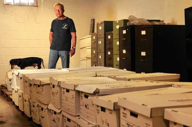 Nearly 50 boxes filled with files of adopted children are stored in the basement of lawyer Robert Lahm's office building in Syracuse. They're left over from the dissolved New Life Adoption Agency, and no one from the agency, the government or other adoption agency will take them. Lahm is offering to get them distributed himself by making a public appeal. At left is Lahm's dachshund Cooper on the boxes. (Michelle Gabel | mgabel@syracuse.com)